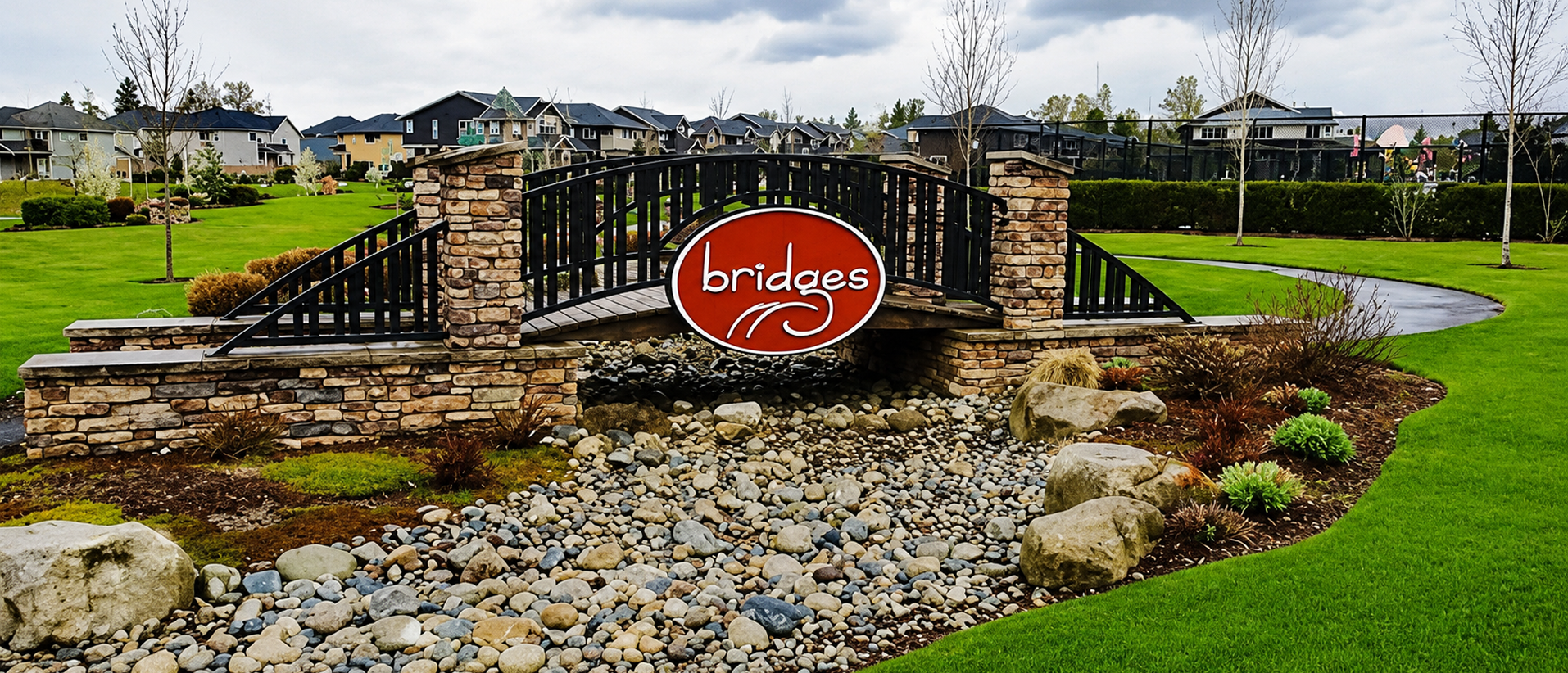 Stone bridge with "Bridges" sign in park.