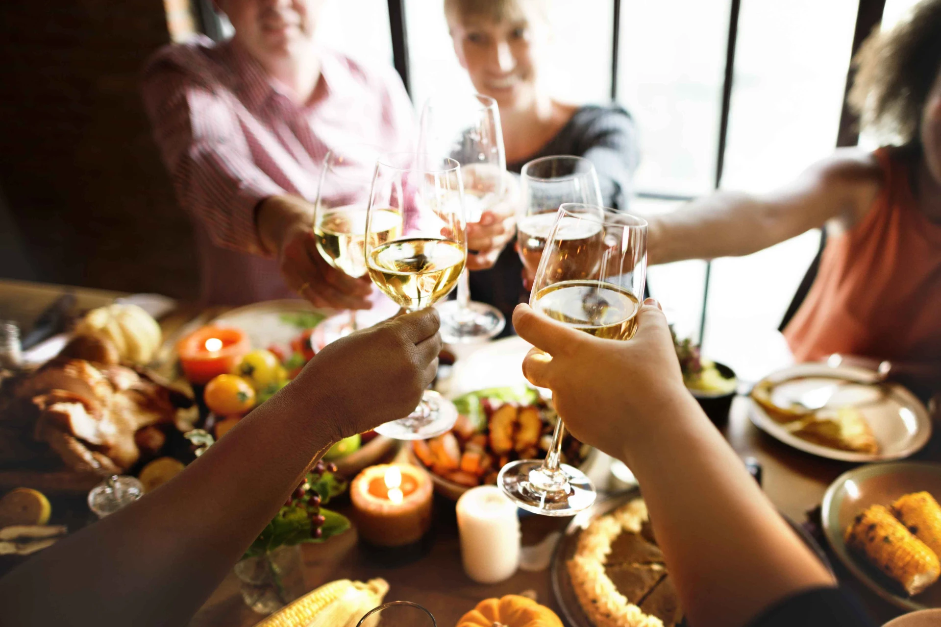 Celebration with friends toasting wine glasses