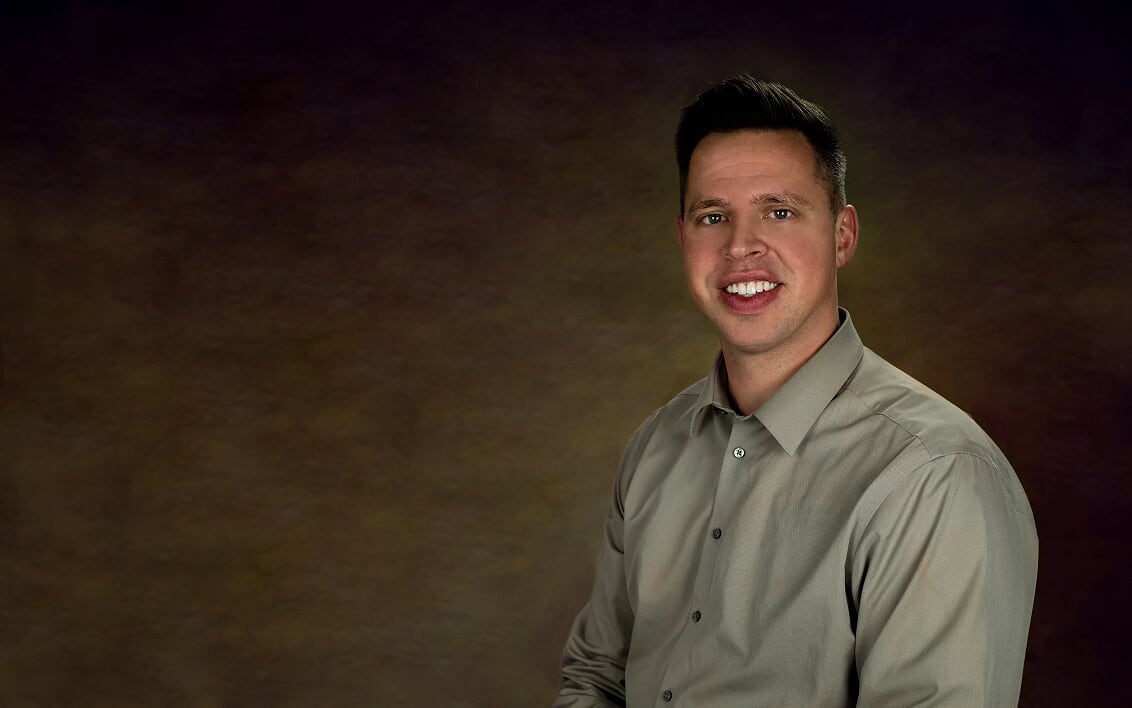 Portrait of a man against dark background