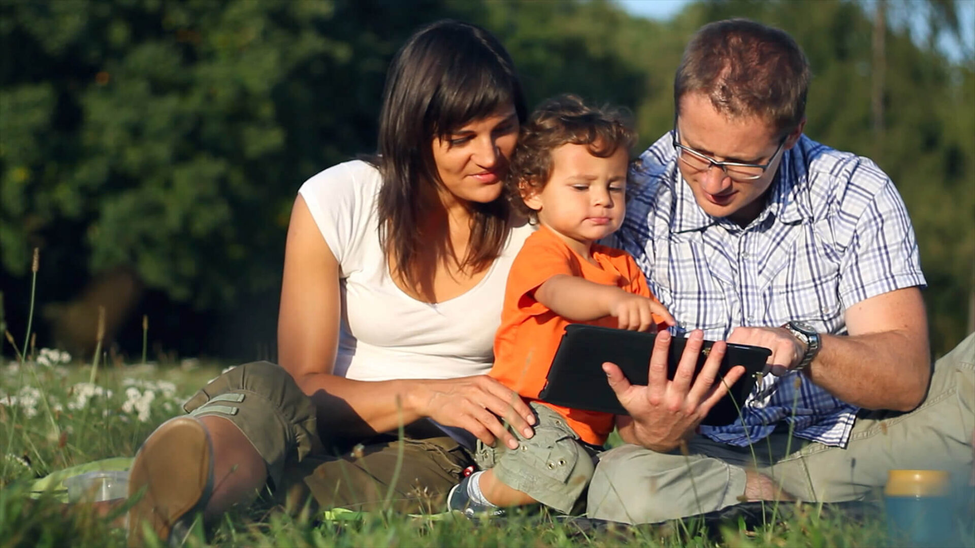 Parents and child using tablet