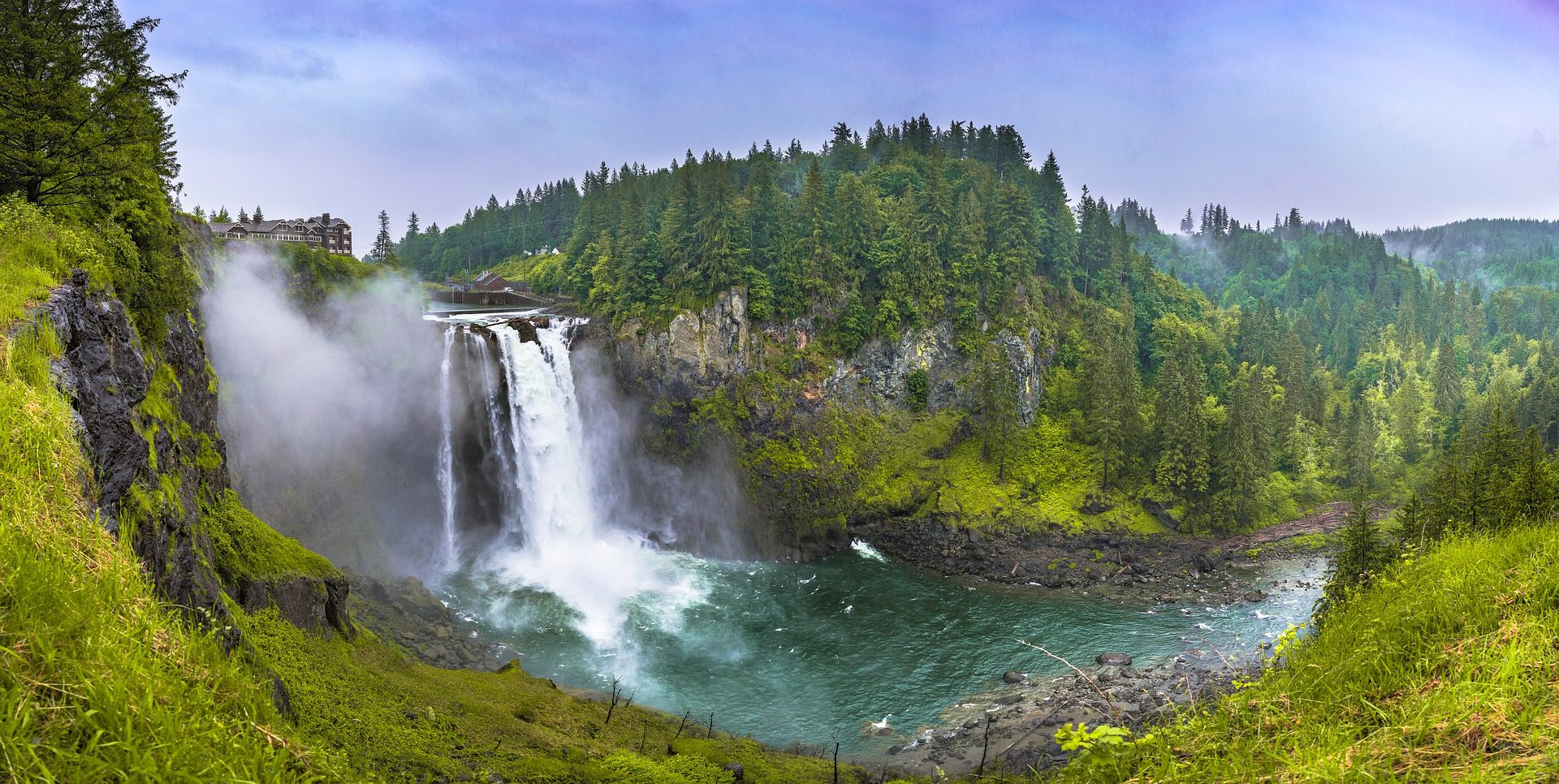 Majestic waterfall with misty surroundings.