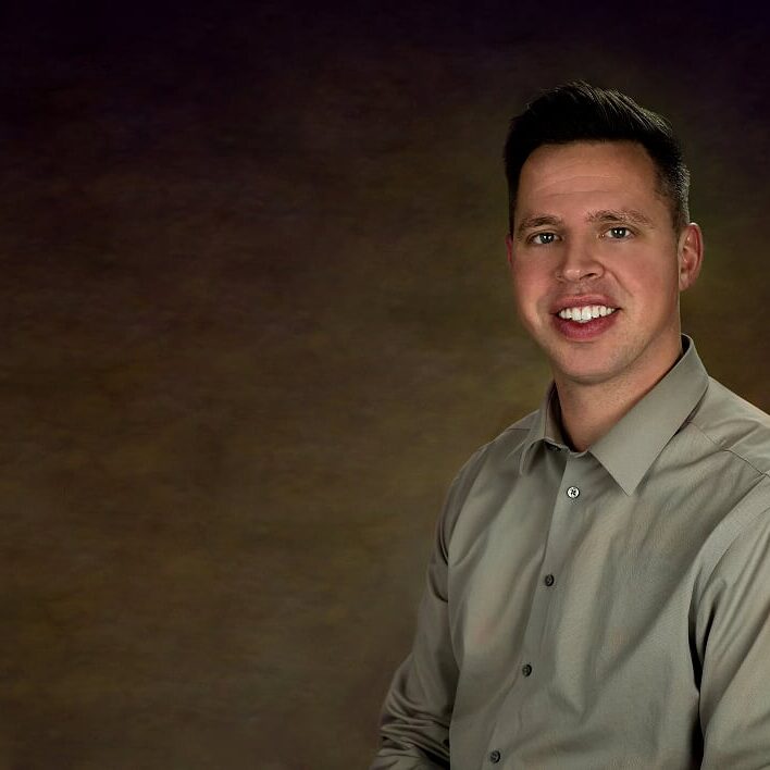 Portrait of a man against dark background